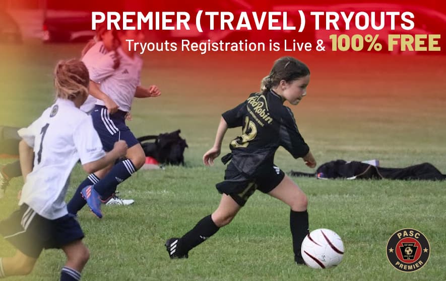 A young female soccer player in a black uniform dribbles a soccer ball down a grass field. A text overlay reads "Premier (Travel) Tryouts, Tryouts Registration is Live & 100% FREE" alongside the PASC Premier logo.